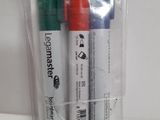 three pens in a clear bag on a table