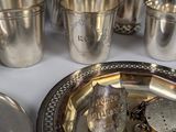 a silver plate with silver cups and saucers on it
