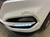 a close up of the front bumper of a white car