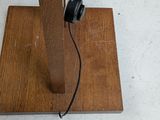 a wooden stand with a pair of headphones on top of it