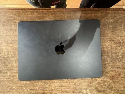 an apple macbook pro laptop sitting on top of a wooden table
