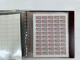 a picture of a binder with a sheet of stamps on it
