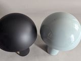 two black and white vases sitting next to each other