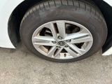 a close up of a tire on a white car