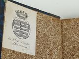 an old book with a picture of a coat of arms and a crown on it
