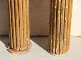two columns that are standing next to each other on the sidewalk