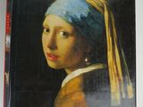 a book with a picture of a girl with a pearl ear