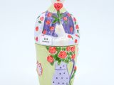 ceramic figurine of a woman with flowers in a vase