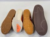 three pairs of shoes are lined up in a row on a white surface