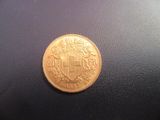 a gold coin with a coat of arms on it