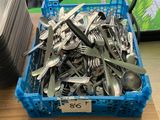 a basket full of forks and spoons on a table