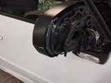 a white car with a speaker in the side of it