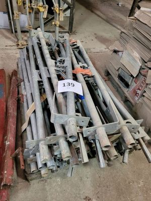 a pile of steel rods and other metal items on the floor