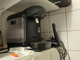 a coffee maker sitting on top of a counter in a kitchen