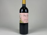 a bottle of wine sitting on top of a white table