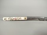 an image of a knife with a flower design on it