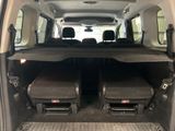two seats in the back of a van with luggage in the back