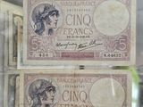 two old french bank notes in a glass case