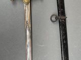 an image of a sword and a sword sheath on a table
