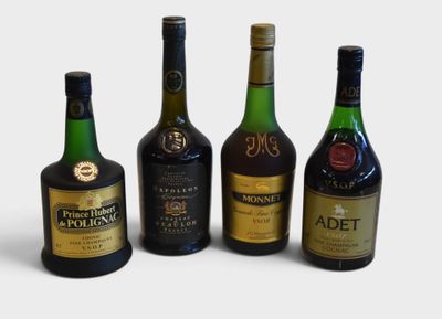 four bottles of alcohol are lined up in a row on a white surface
