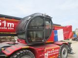 a red crane that is parked in front of a building