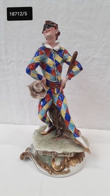an image of a figurine of a clown holding a baseball bat