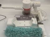 a mop and a duster on a counter top