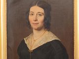 portrait of a woman in a black dress with a gold necklace