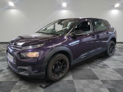 the purple car is parked on a checkered floor in the garage