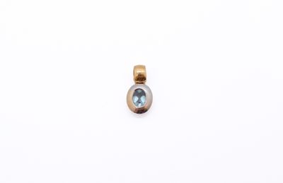 a gold and blue topaze stone pendant on a white background