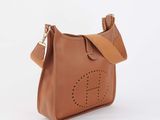 a brown handbag with the letter g on it