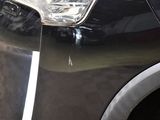 a close up of a car ' s headlight on the side of the road