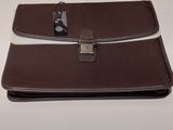 an image of a brown and white briefcase sitting on top of a table