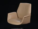 an image of a tan leather office chair against a black background