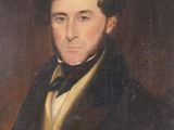 portrait of a man in a black coat with a white shirt and a black bow tie