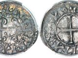 a close up of two silver coins on a white surface
