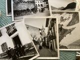 several old black and white photos of people and buildings on a bed