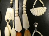 several pieces of jewelry are displayed on a black surface