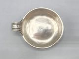 an image of a silver cup on a white surface