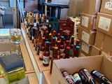 many boxes of alcohol on the counter in the store