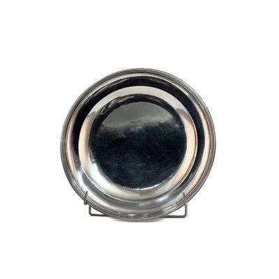 a silver plate on a stand on a white background