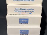 four white boxes stacked on top of each other on a table
