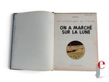 an open book with a picture of a man on a motorcycle in the background