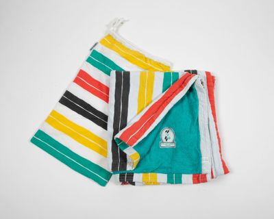 a close up of two colorful towels on a white surface