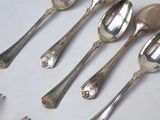 five spoons and two spoons sitting on a table
