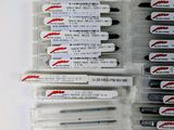 several pens are lined up on top of each other on a white surface