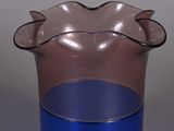 a blue and pink vase sitting on a table