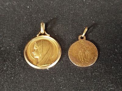 a close up of two gold coins on a black surface