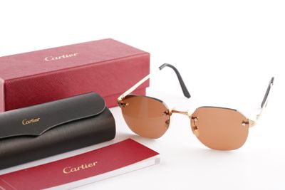cartier sunglasses with box and case on a white surface