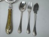 a lot of spoons, forks, and spoons on the table